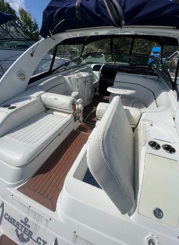 Slide: The Image of 2003 Cobalt 360 boat interior with white seating and wood flooring. - 12