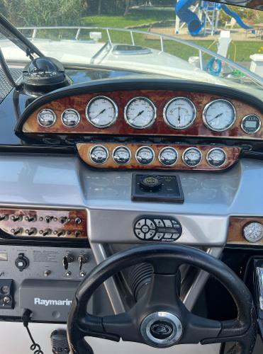 Slide: The Image of 2003 Cobalt 360 boat dashboard with gauges and steering wheel. - 23