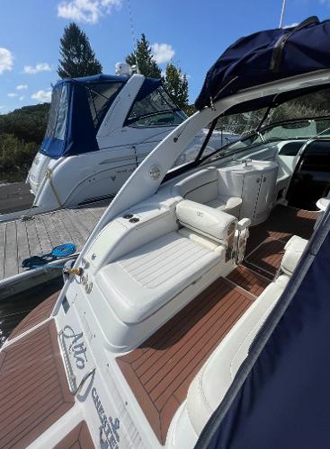 Slide: The Image of 2003 Cobalt 360 boat docked, featuring spacious seating and sleek design. - 7