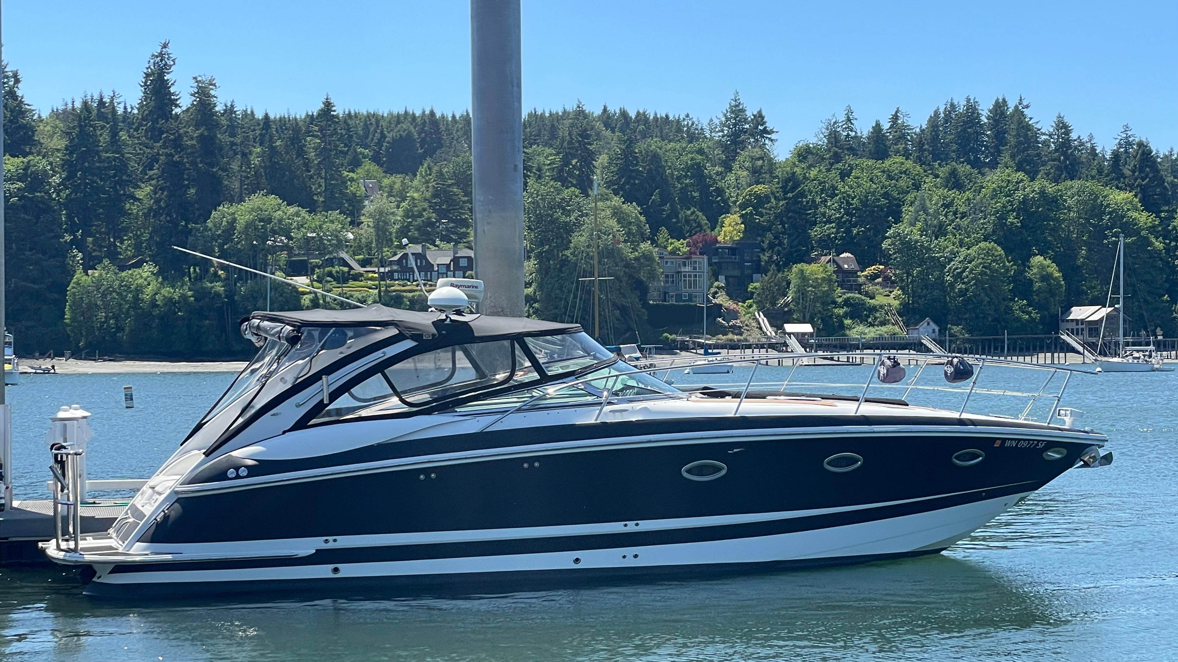 Slide: The Image of 2004 Cobalt 360 boat docked in a scenic marina with lush green trees. - 1