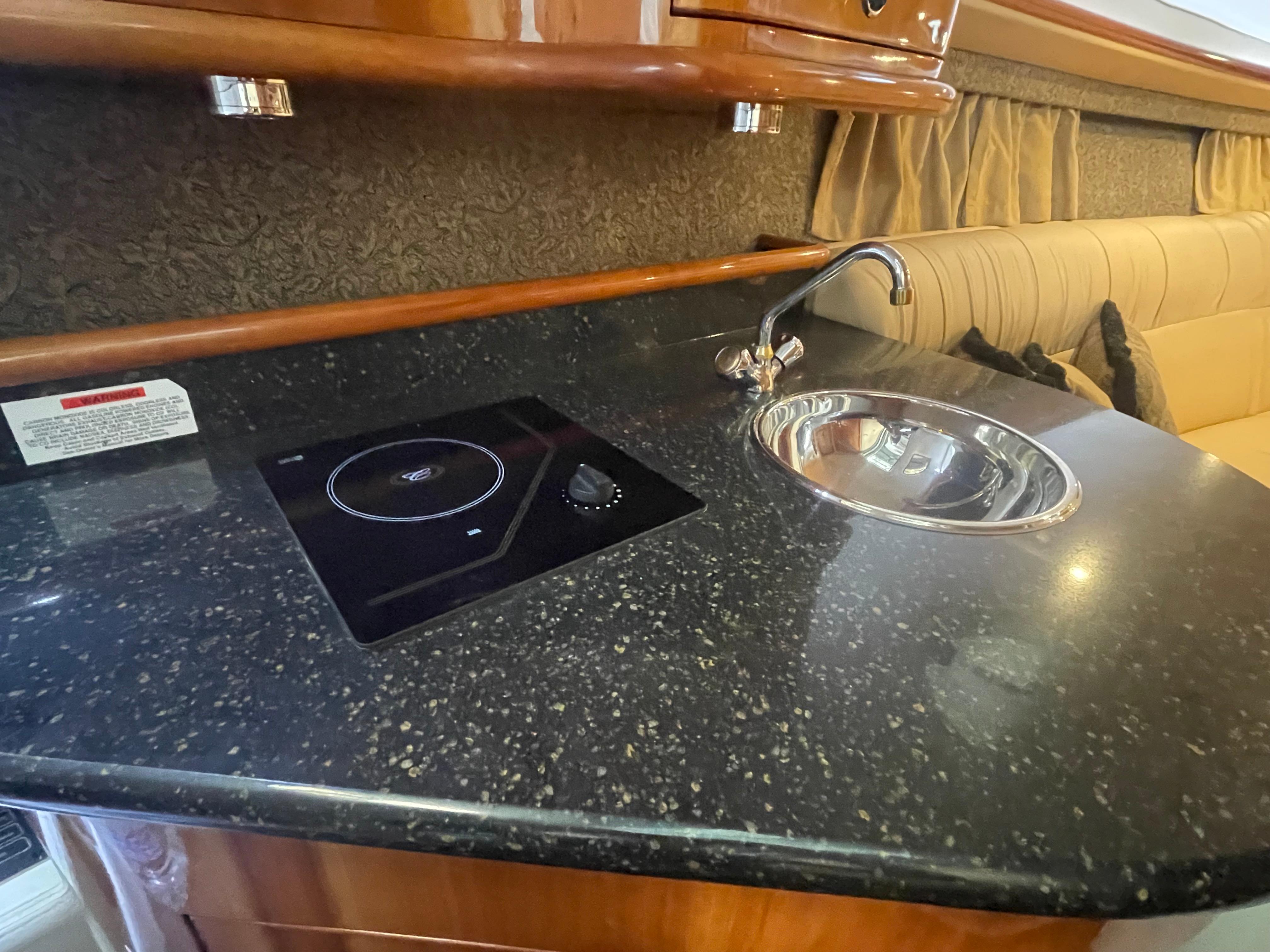 Slide: The Image of Luxurious 2004 Cobalt 360 yacht interior with sleek kitchenette and modern amenities. - 20