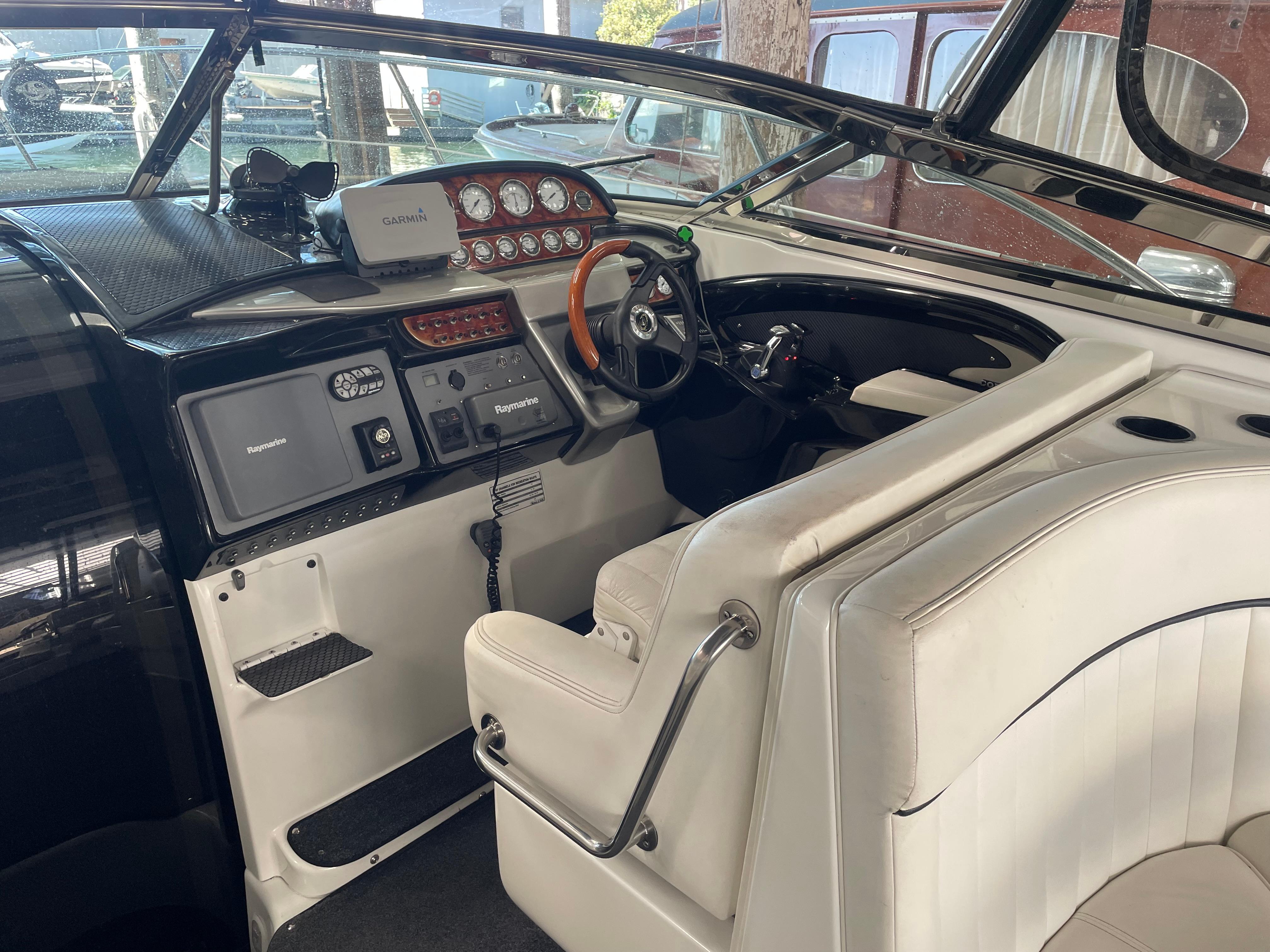 Slide: The Image of Interior of a 2004 Cobalt 360 boat with steering wheel and navigation equipment. - 3