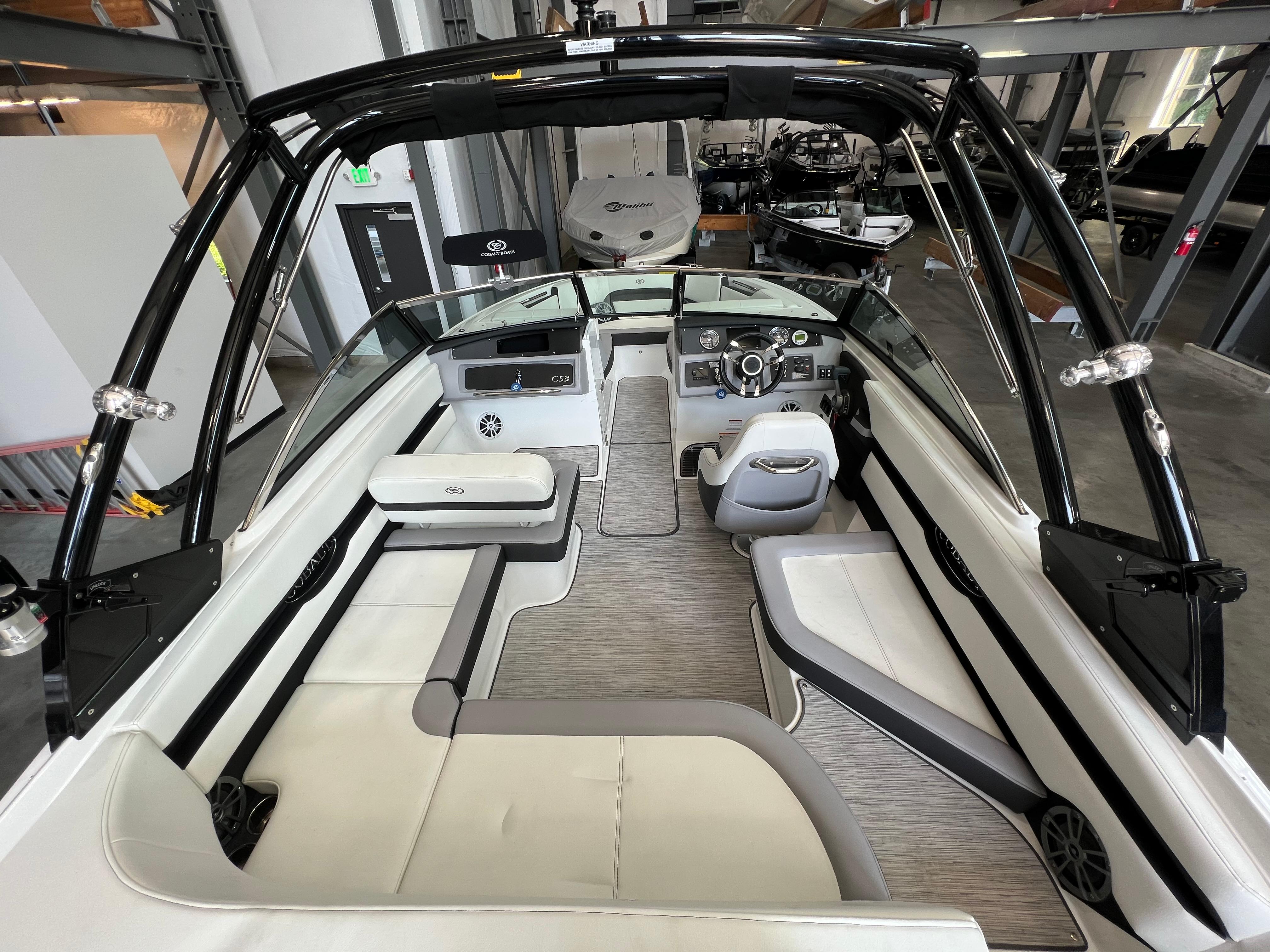 Slide: The Image of 2023 Cobalt CS23 Surf boat interior with modern seating and steering console. - 10