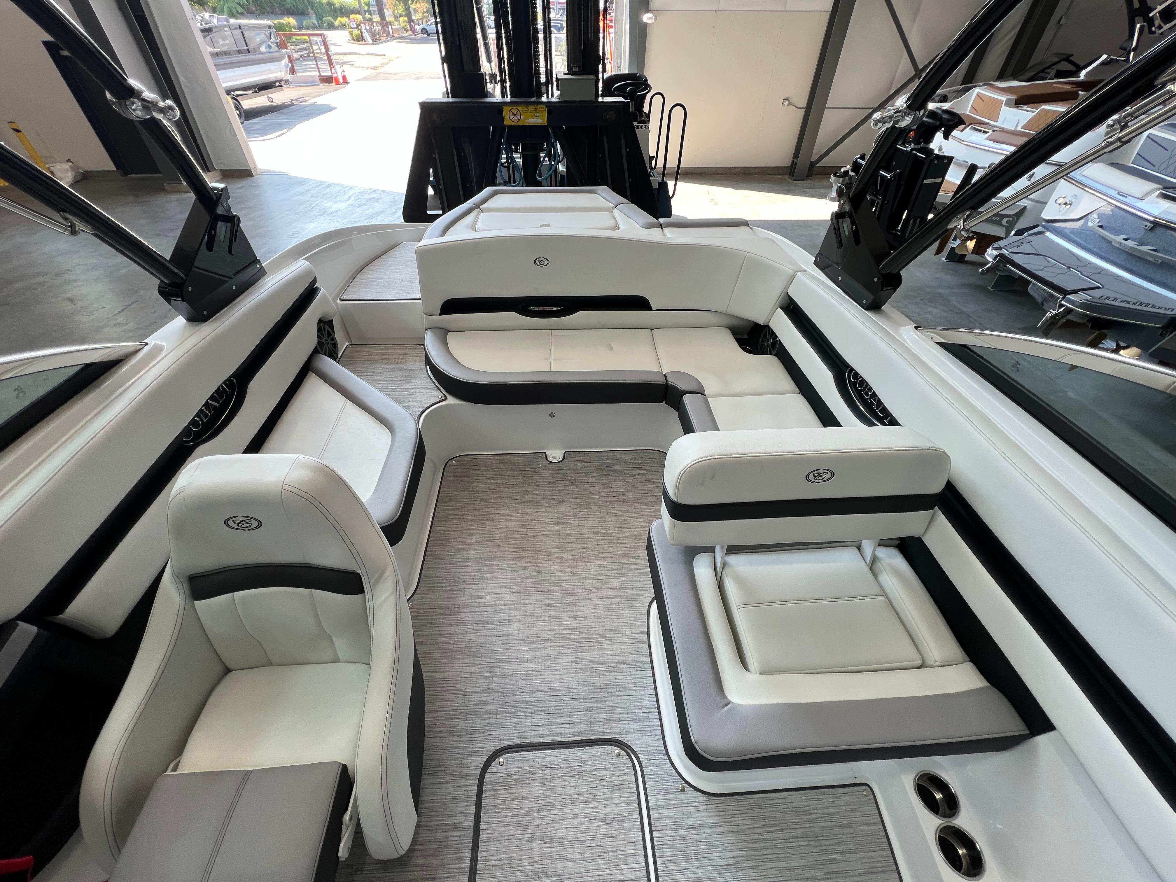 Slide: The Image of 2023 Cobalt CS23 Surf boat interior with white and black seating, modern design. - 11