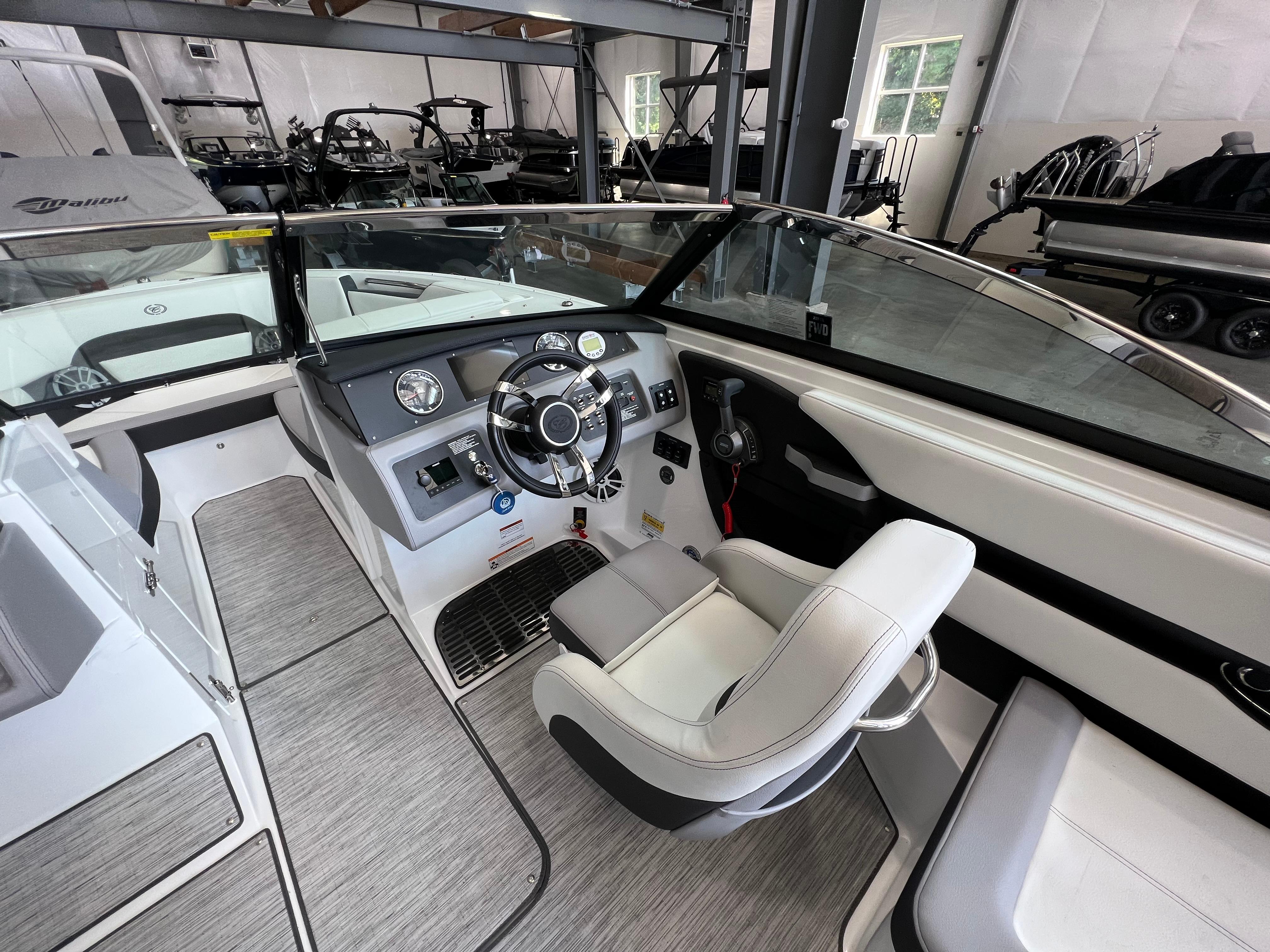 Slide: The Image of 2023 Cobalt CS23 Surf boat interior with modern dashboard and captain's chair. - 13