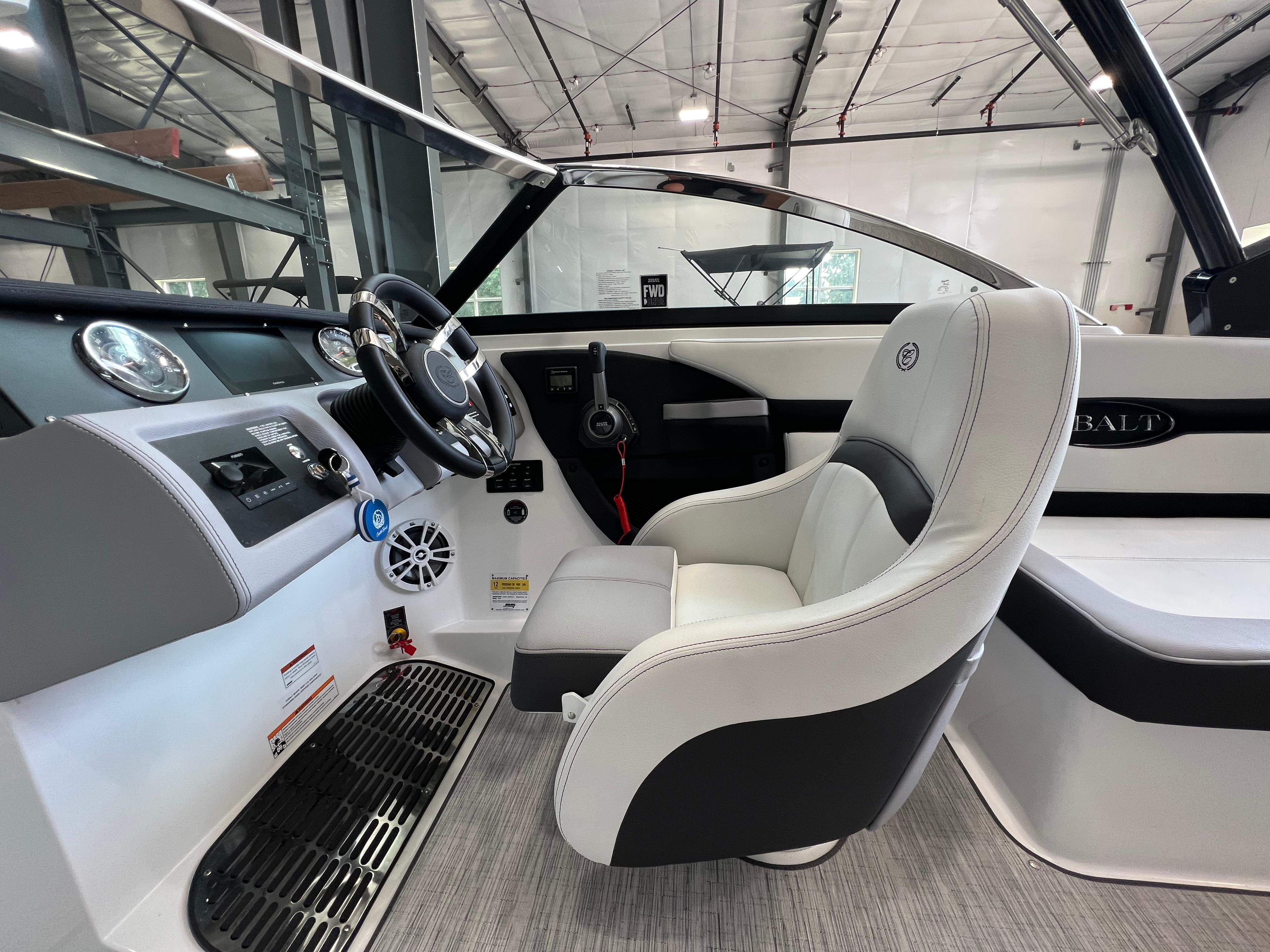 Slide: The Image of 2023 Cobalt CS23 Surf boat interior with steering wheel and captain's chair. - 14
