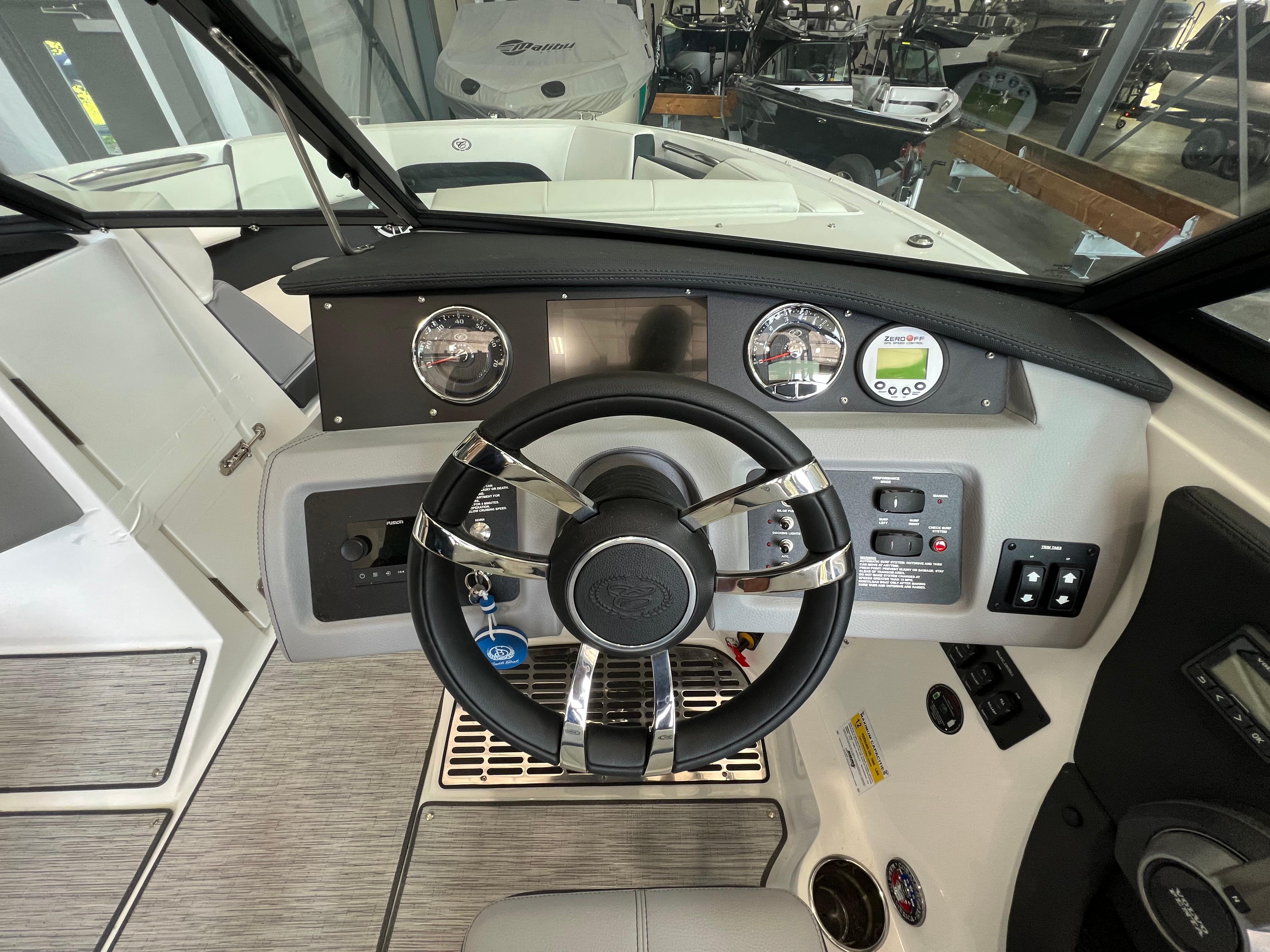 Slide: The Image of 2023 Cobalt CS23 Surf boat dashboard with steering wheel and control panel. - 15