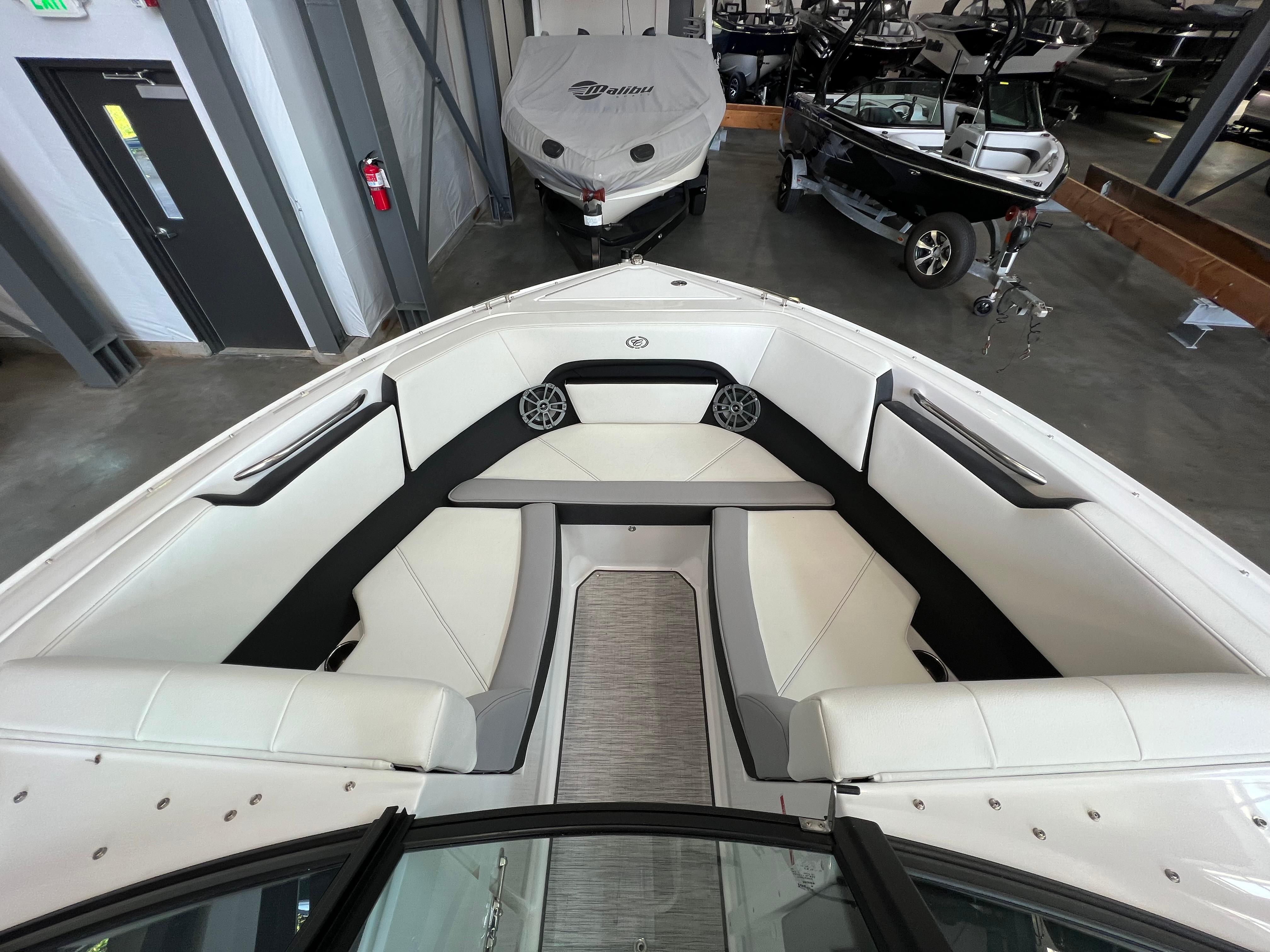Slide: The Image of 2023 Cobalt CS23 Surf boat interior with white seating and modern design. - 16
