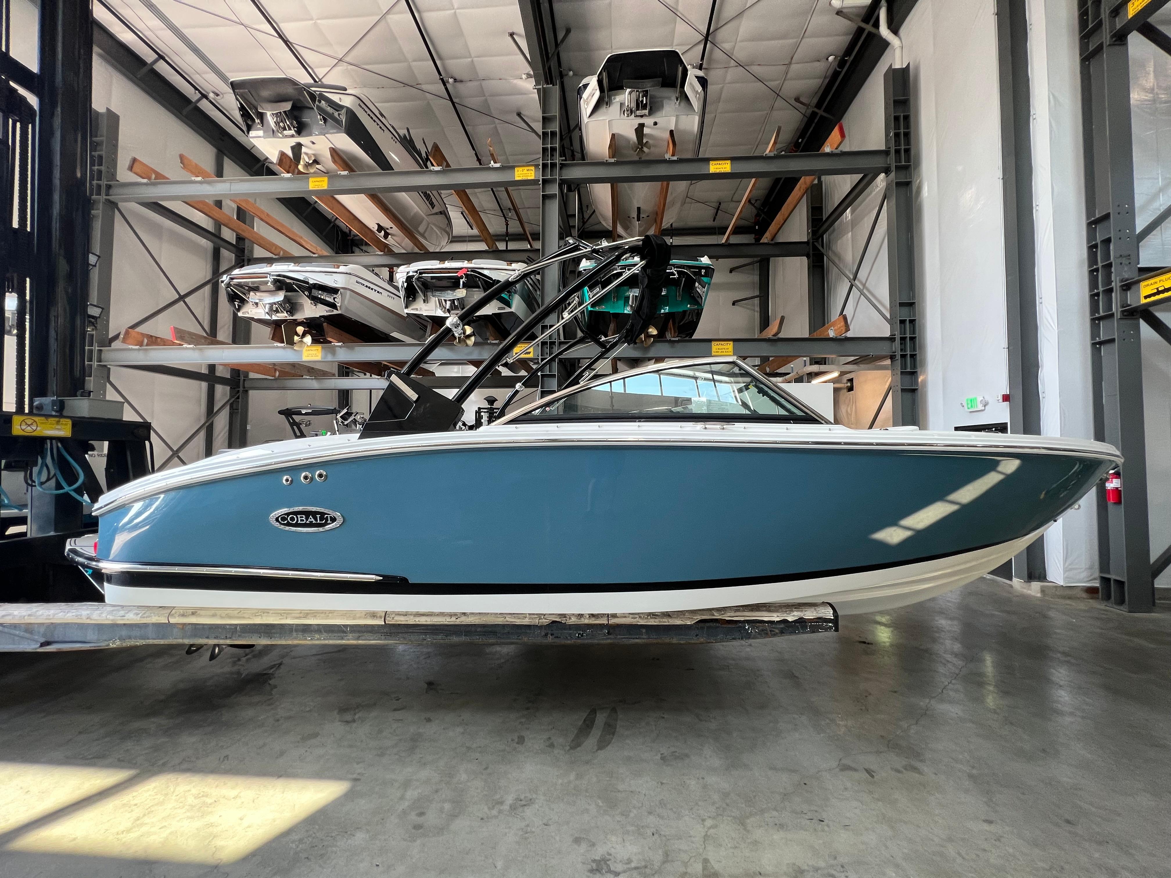 Slide: The Image of 2023 Cobalt CS23 Surf boat in storage facility. - 5