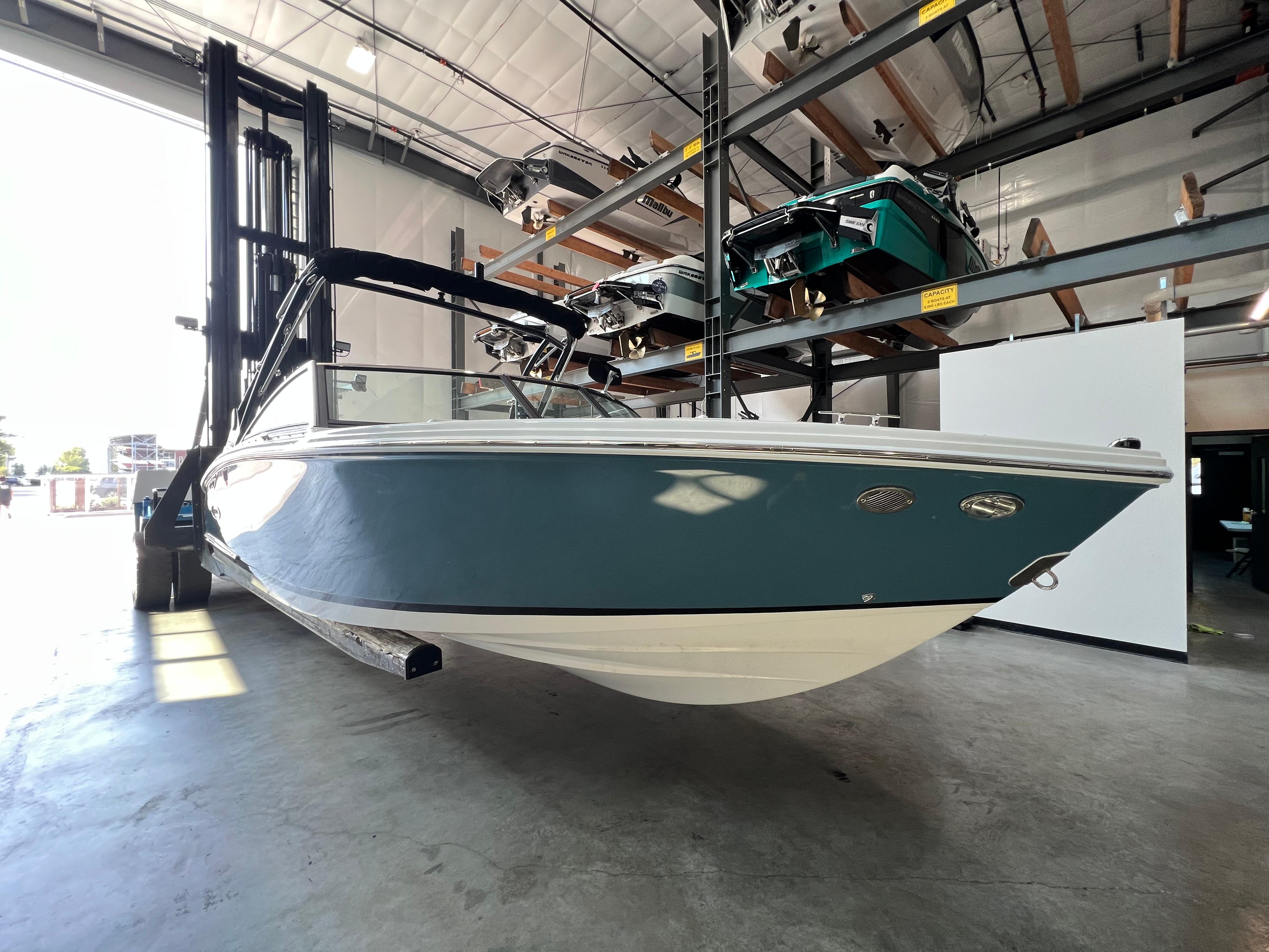 Slide: The Image of 2023 Cobalt CS23 Surf boat in indoor storage facility. - 6