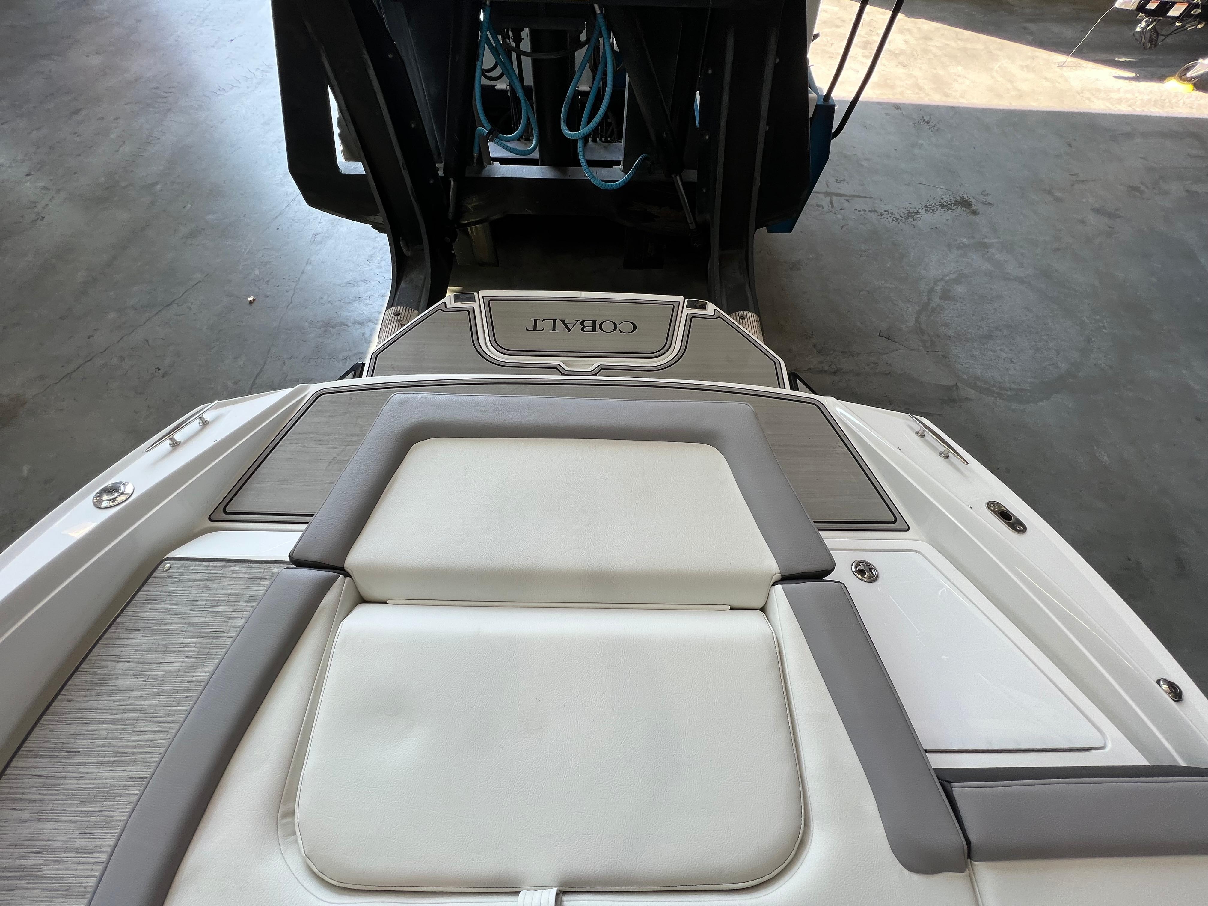 Slide: The Image of 2023 Cobalt CS23 Surf boat interior with cushioned seating and deck. - 9