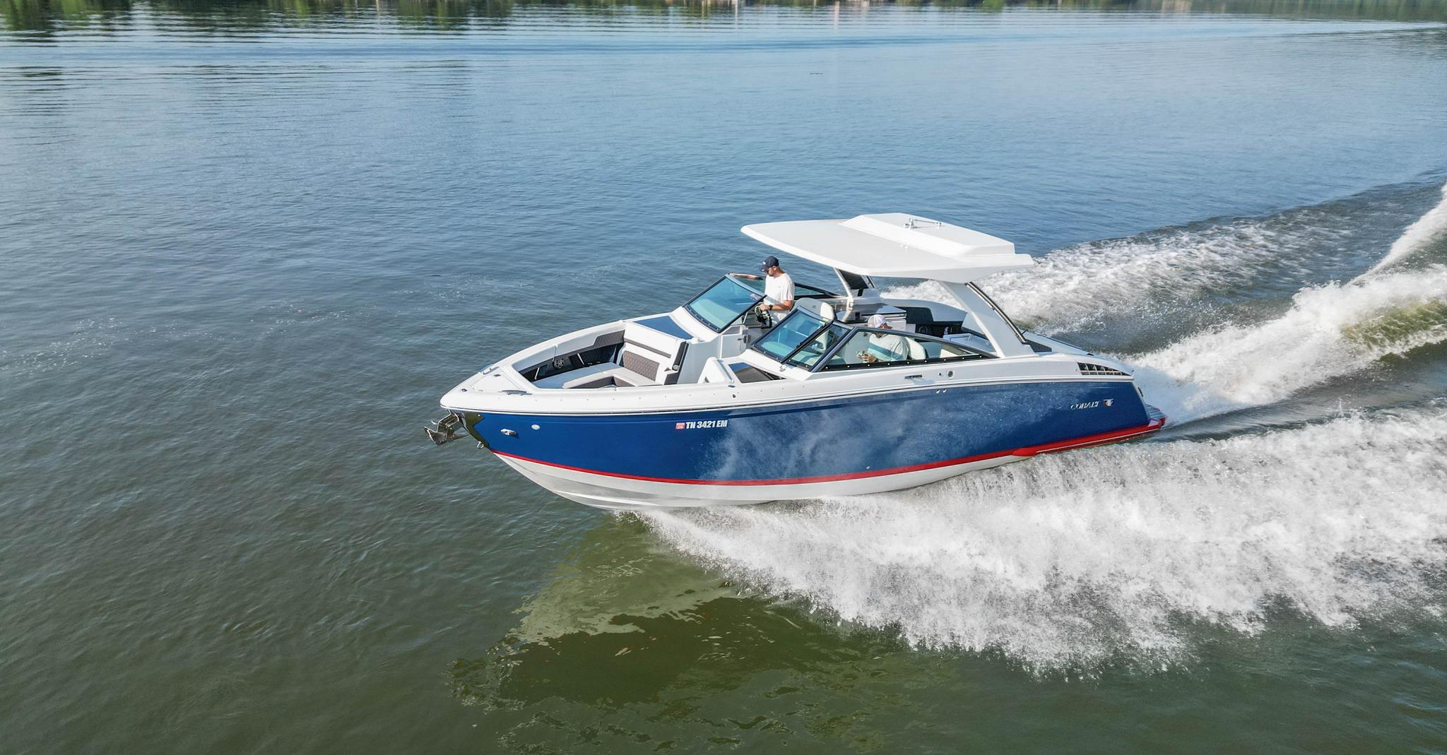 Slide: The Image of 2023 Cobalt R33 boat cruising on a calm lake, showcasing sleek design and performance. - 1