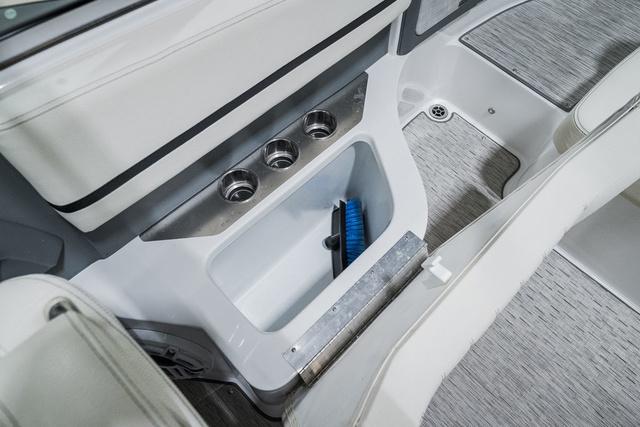 Slide: The Image of 2021 Cobalt R5 Surf boat interior storage compartment with brush. - 15