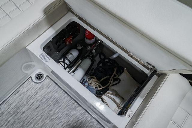 Slide: The Image of Storage compartment in 2021 Cobalt R5 Surf boat with safety equipment and ropes. - 16