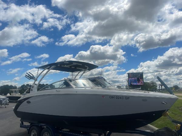 Slide: The Image of 2021 Cobalt R5 Surf boat on trailer under a partly cloudy sky. - 2