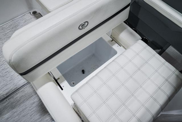 Slide: The Image of 2021 Cobalt R5 Surf boat interior with white cushioned seating and storage compartment. - 20