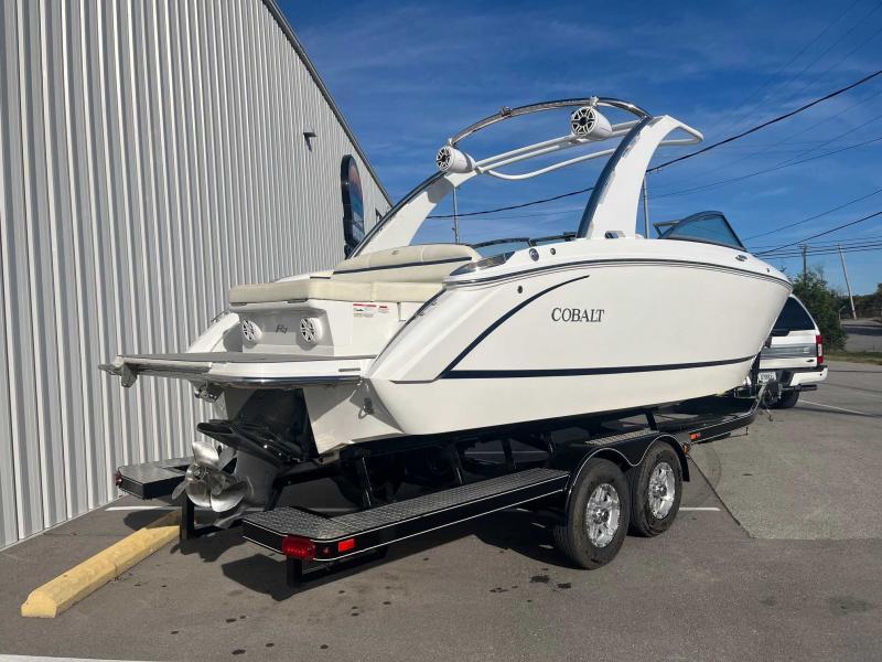 Slide: The Image of 2021 Cobalt R7 boat on trailer, parked outdoors near a building. - 4