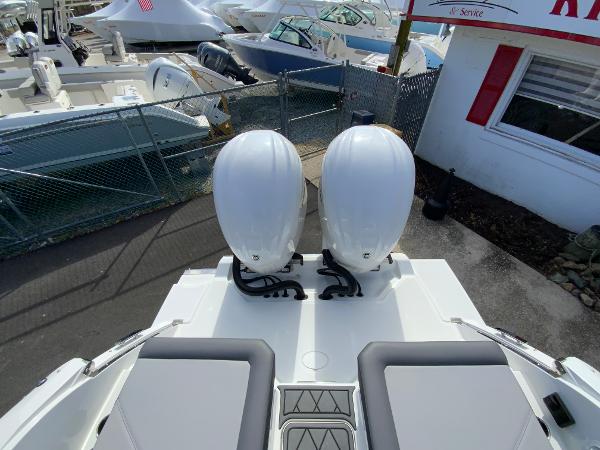 Slide: The Image of 2024 Cobalt R8 Outboard boat with twin engines at a marina. - 13