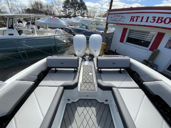 Slide: The Image of 2024 Cobalt R8 Outboard boat with dual engines at a dealership. - 16