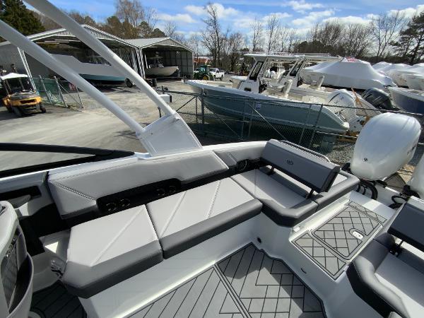 Slide: The Image of 2024 Cobalt R8 Outboard boat interior with gray seating and deck, docked at marina. - 17
