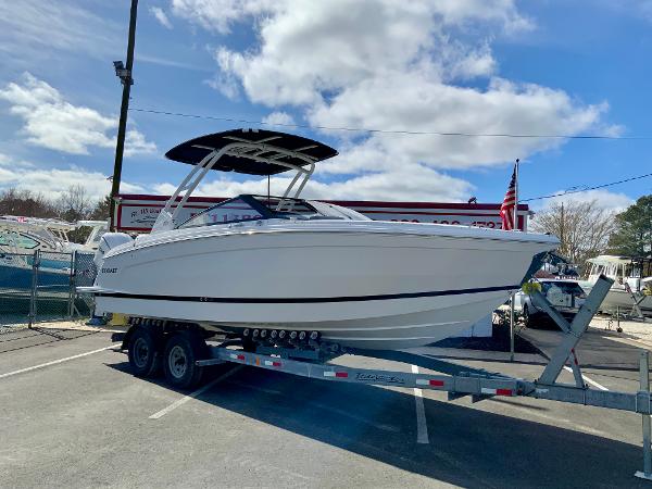 Slide: The Image of 2024 Cobalt R8 Outboard boat on a trailer in a marina parking lot. - 2