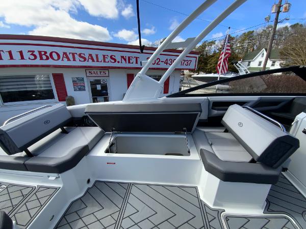 Slide: The Image of 2024 Cobalt R8 Outboard boat interior with open storage compartment at a boat sales dealership. - 20