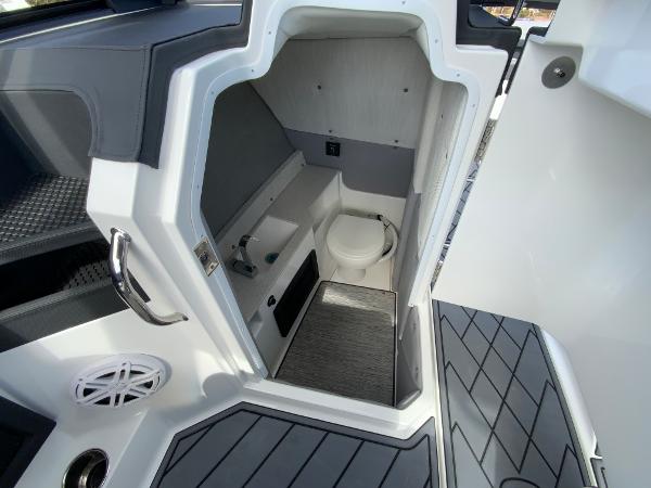 Slide: The Image of 2024 Cobalt R8 Outboard boat interior with a compact bathroom. - 27