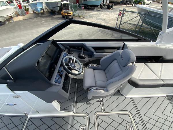Slide: The Image of 2024 Cobalt R8 Outboard boat cockpit with modern steering wheel and comfortable seating. - 28