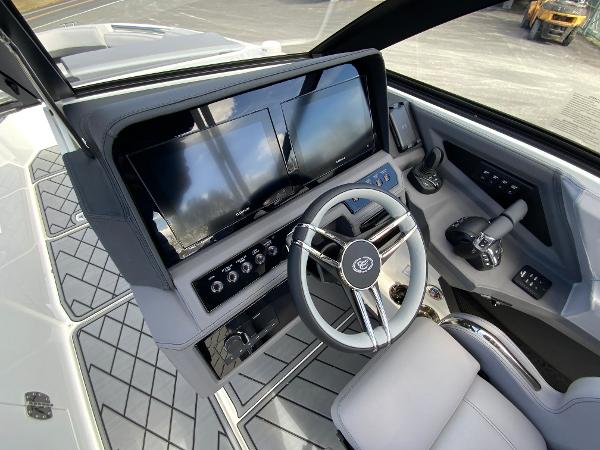 Slide: The Image of 2024 Cobalt R8 Outboard boat cockpit with dual screens and modern steering wheel. - 29