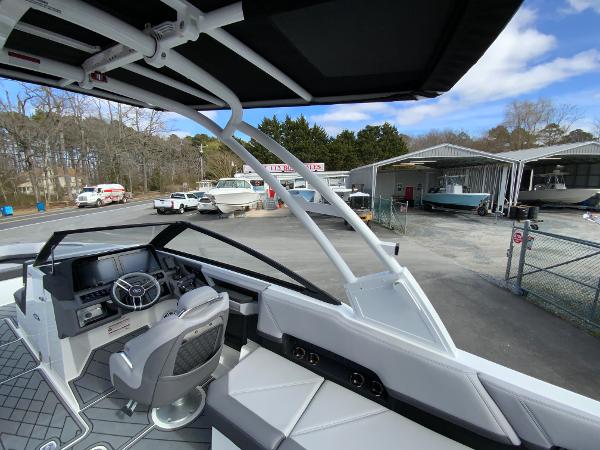 Slide: The Image of 2024 Cobalt R8 Outboard boat interior at a marina with other boats. - 34