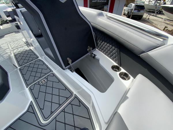 Slide: The Image of 2024 Cobalt R8 Outboard boat interior with storage compartment and cup holders. - 48