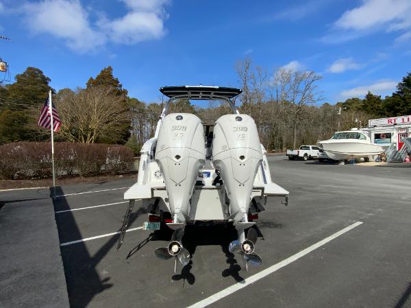 Slide: The Image of 2024 Cobalt R8 Outboard boat with twin engines in a parking lot. - 9