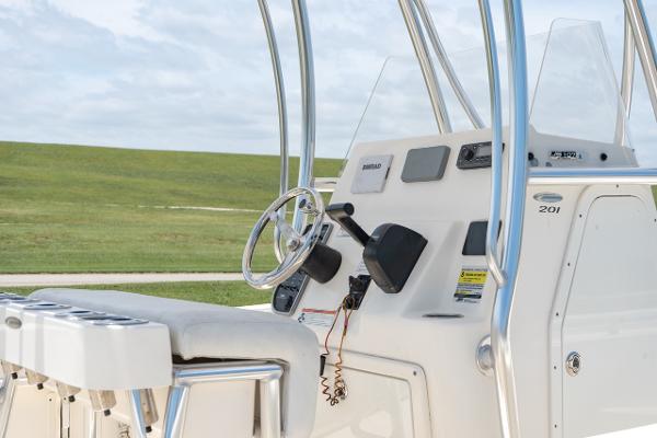 Slide: The Image of 2021 Cobia 201 Center Console boat helm with steering wheel and controls. - 14