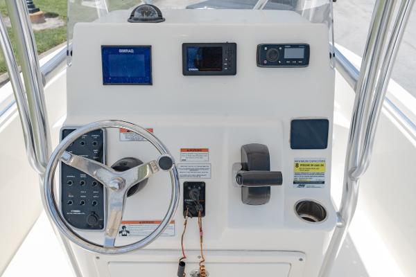 Slide: The Image of Cobia 201 Center Console 2021 boat dashboard with steering wheel and navigation controls. - 15