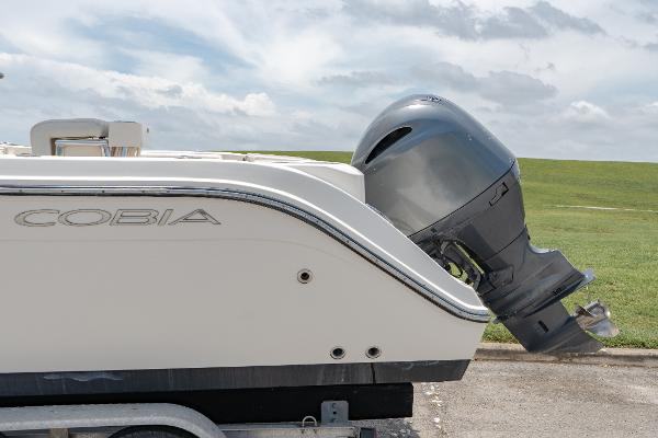 Slide: The Image of 2021 Cobia 201 Center Console boat with outboard motor on trailer. - 6