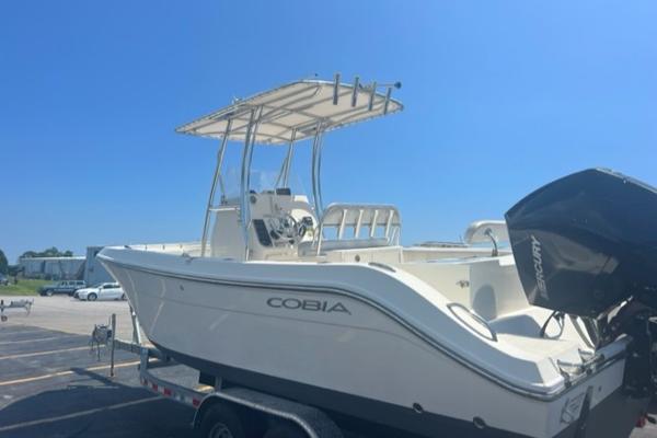 Slide: The Image of 2020 Cobia 237CC center console boat on a trailer with Mercury outboard motor. - 1