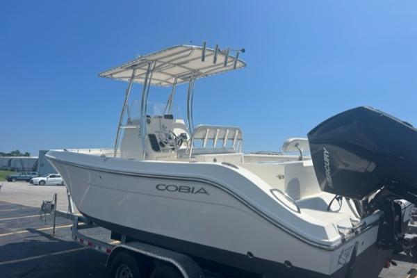 Slide: The Image of 2020 Cobia 237CC center console boat on trailer with Mercury outboard motor. - 2