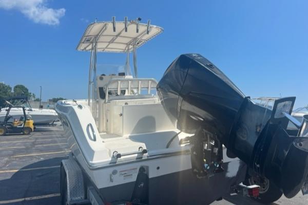 Slide: The Image of 2020 Cobia 237CC center console boat with outboard motor in a parking lot. - 5