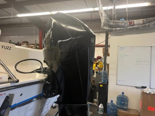 Slide: The Image of 2020 Cobia 237CC boat with Mercury outboard motor in a workshop. - 7