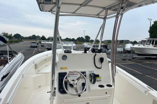 Slide: The Image of 2021 Cobia 237 Center Console boat interior with steering wheel and controls. - 8