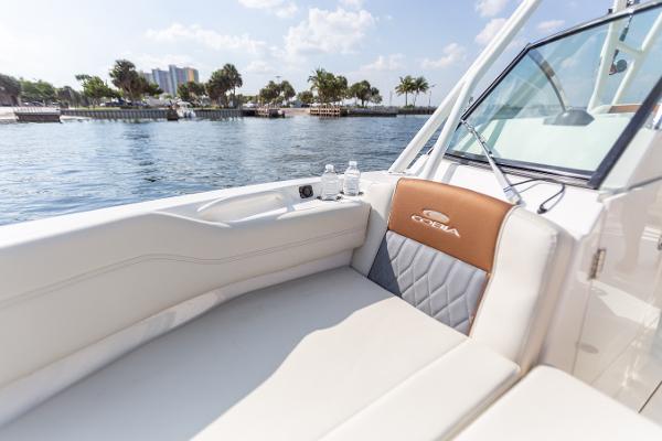 Slide: The Image of 2022 Cobia 240 DC boat interior with water view, featuring comfortable seating. - 33