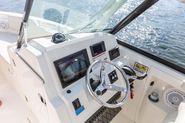 Slide: The Image of Manufacturer Provided Image: 2023 Cobia 240 Dual Console boat dashboard with steering wheel and navigation screens. - 10