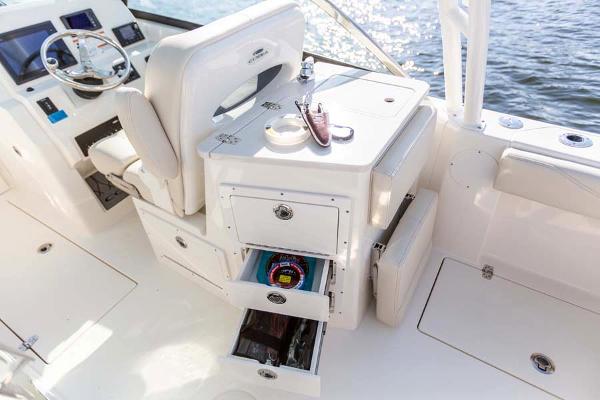 Slide: The Image of Manufacturer Provided Image: 2023 Cobia 240 Dual Console boat interior with storage drawers and helm station. - 12