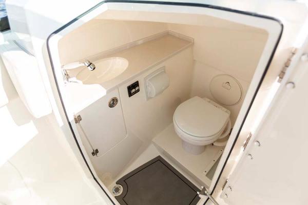 Slide: The Image of Manufacturer Provided Image: 2023 Cobia 240 Dual Console boat interior bathroom with sink and toilet. - 17