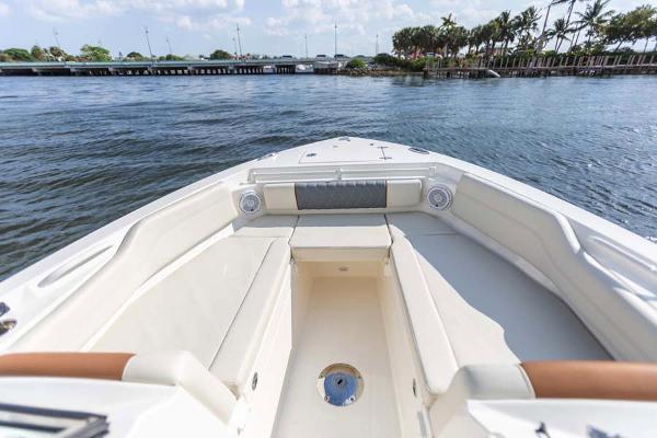 Slide: The Image of Manufacturer Provided Image: 2023 Cobia 240 Dual Console boat interior with spacious seating and scenic water view. - 2
