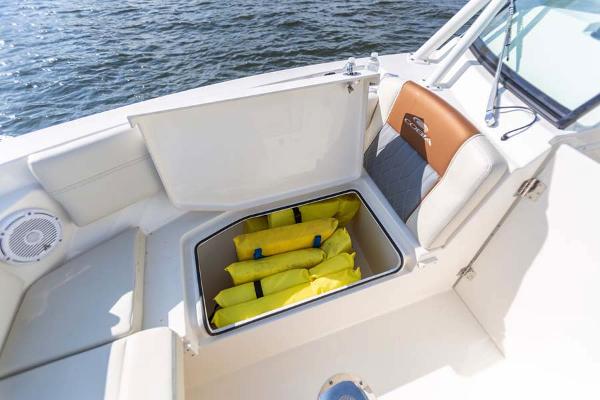 Slide: The Image of Manufacturer Provided Image: 2023 Cobia 240 Dual Console boat with storage compartment and life jackets. - 5