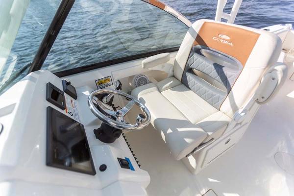 Slide: The Image of Manufacturer Provided Image: 2023 Cobia 240 Dual Console boat interior with captain's seat and steering wheel. - 9