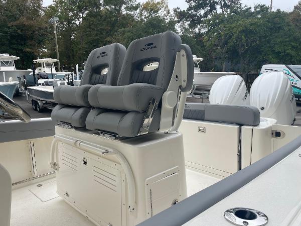 Slide: The Image of 2024 Cobia 262 Center Console boat with dual seats and storage compartments. - 5