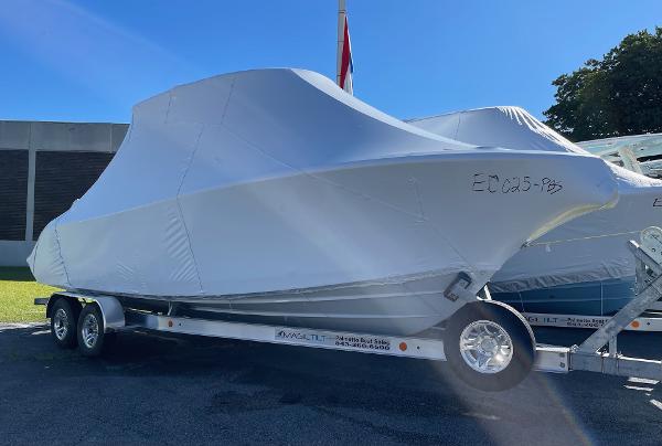 Slide: The Image of 2024 Cobia 262 Center Console boat covered on a trailer. - 7