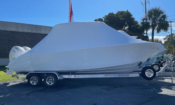 Slide: The Image of 2024 Cobia 262 Center Console boat covered on a trailer. - 8